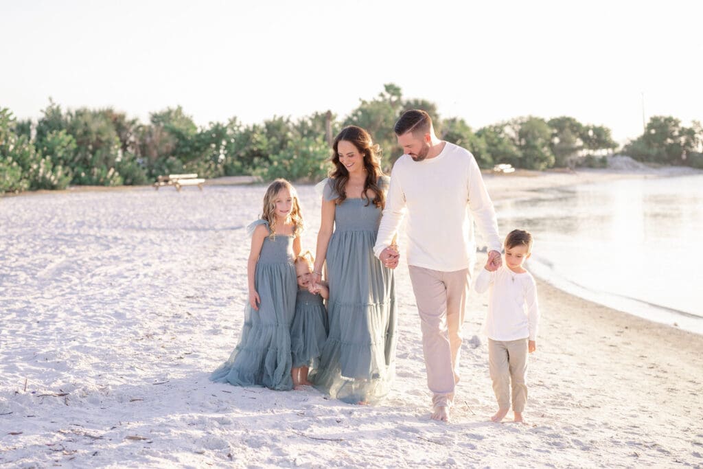 Family of 5 walking on the beach for their family session